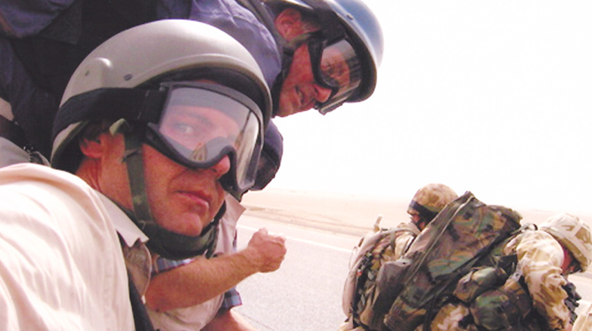 Brent Sadler and CNN cameraman Christian Streib (foreground) prepare to board a US helicopter for a mission in Iraq