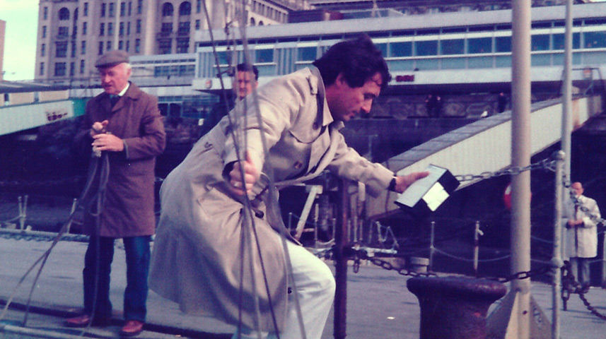 Brent Sadler disembarks a boat on the River Mersey with urgent news video tapes for transmission from Liverpool, UK