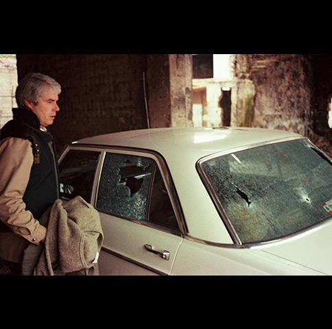 Soundman Alan Florence next to ITN's car riddled with bullets