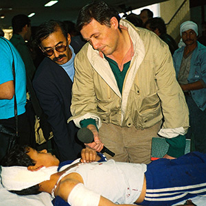 Gulf War One, 1991. Sadler interviews a wounded Iraqi child after a coalition air strike