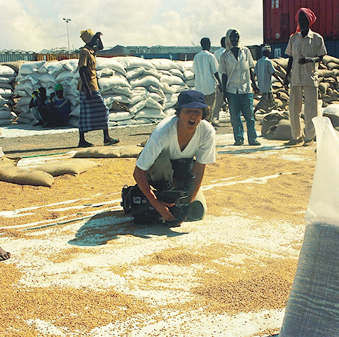 Mogadishu 1992 during Somalia famine – CNN camerawoman Cynde Strand shoots pictures of rice granules scattered in the dirt that had fallen from food aid delivery trucks